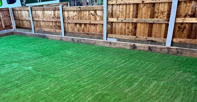 Artificial grass beside a closeboard timber fence