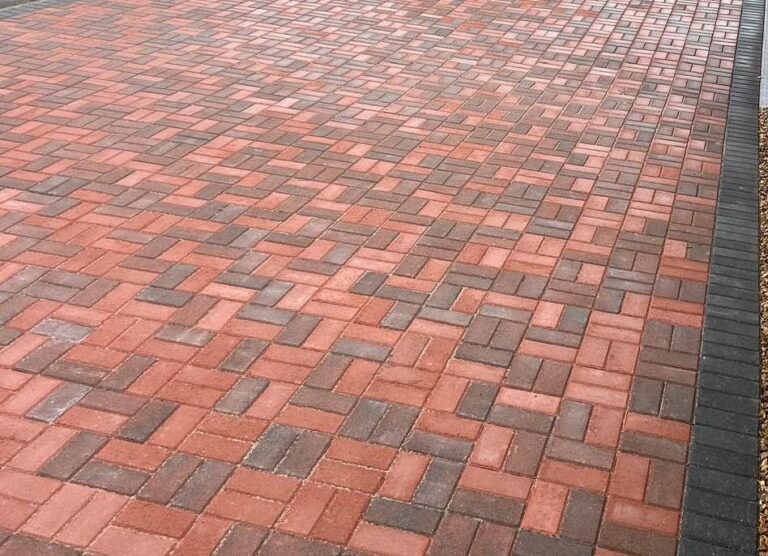 Red basketweave block paving with a charcoal border