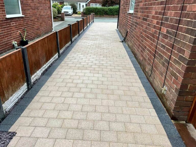 Stretcher bond block paved path down the side of a house
