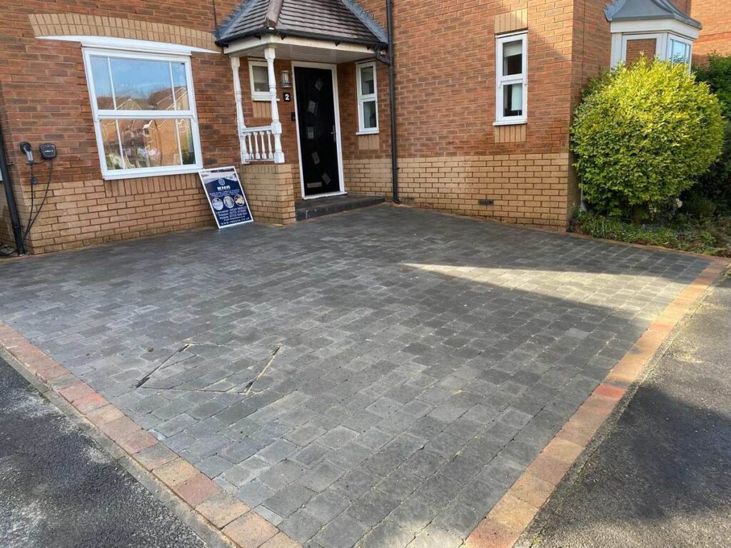 Charcoal block paved driveway with a buff border