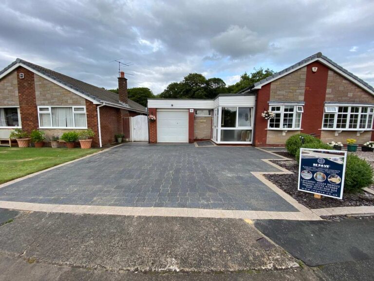 Charcoal block paved driveway with a buff border at a bungalow