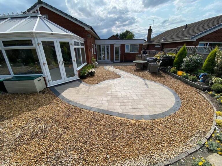Circular block paved patio surrounded by gravel