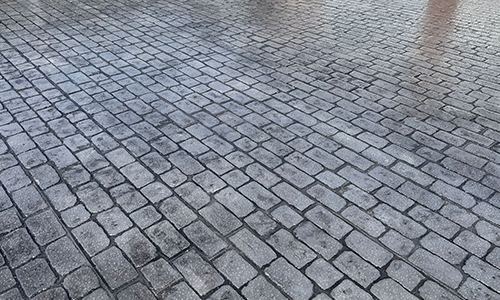 Close-up of grey cobble pattern imprinted concrete