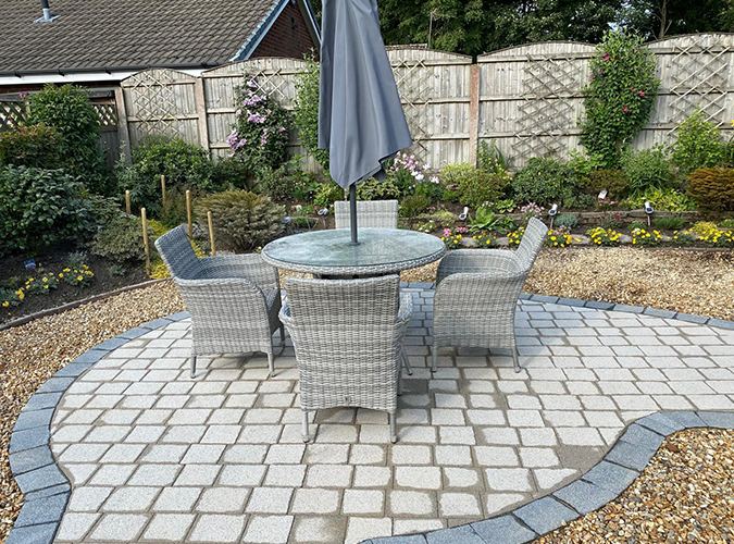 Circular cobble patio with garden furniture