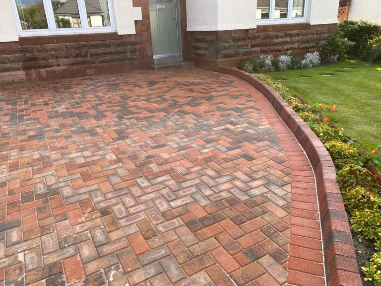Curved red block paved driveway with a charcoal edge