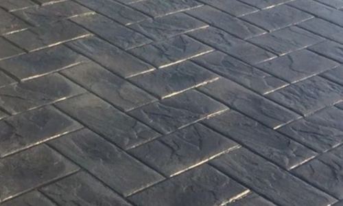 Dark herringbone pattern imprinted concrete