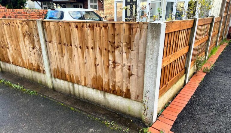 Featheredge timber fence on concrete posts