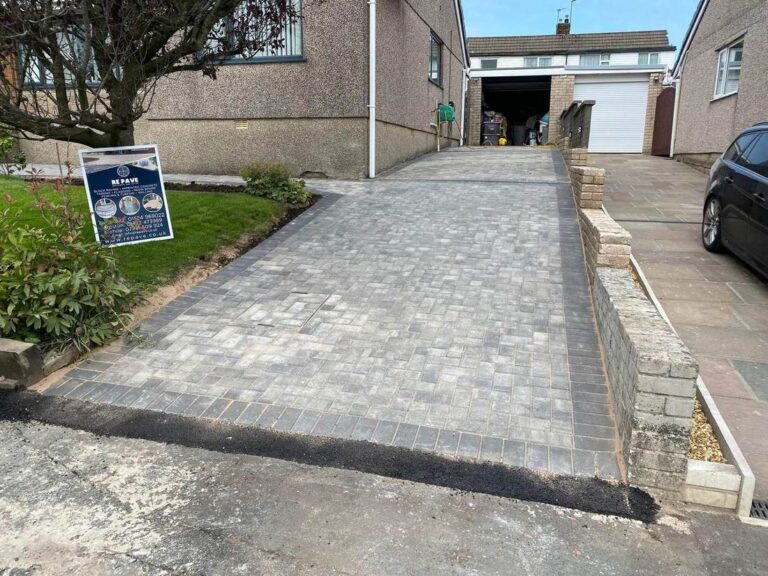 Grey block paved driveway up a slope