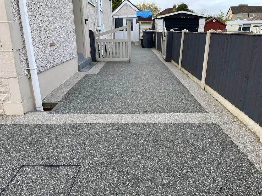 Grey resin bound path down the side of a house