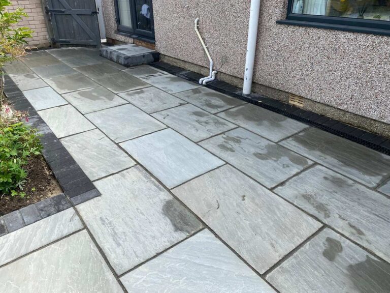Grey sandstone patio with a charcoal border