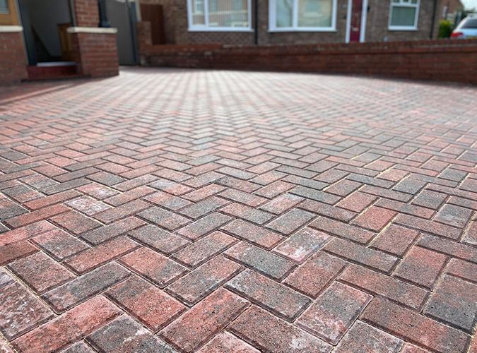 Close-up of red herringbone block paving