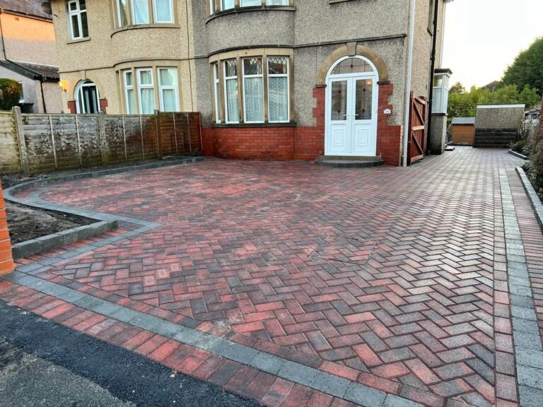 Herringbone block paved driveway with a charcoal border at a semi