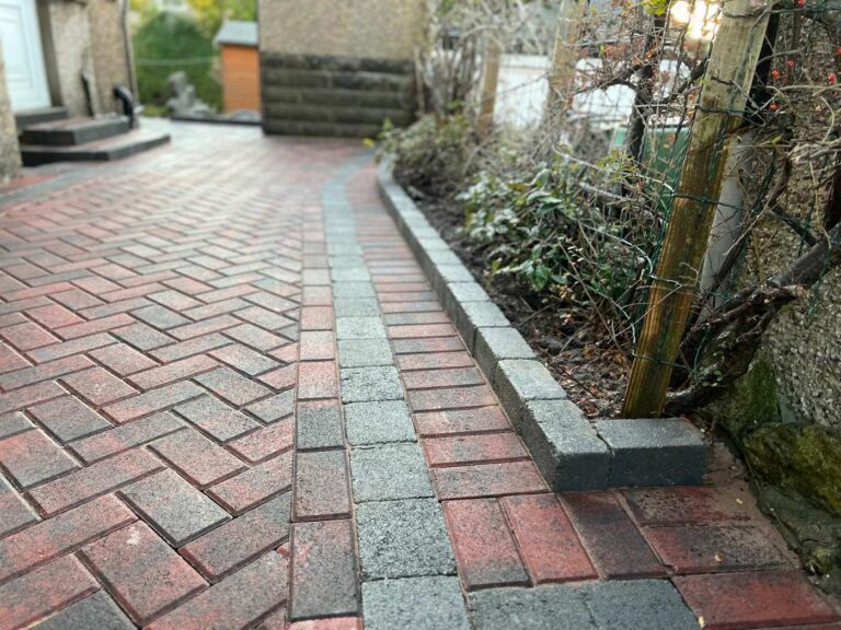 Herringbone block paved path with a granite edge