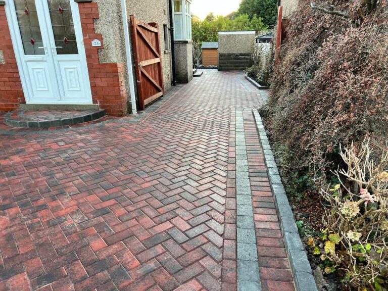 Herringbone block paved path down the side of a house