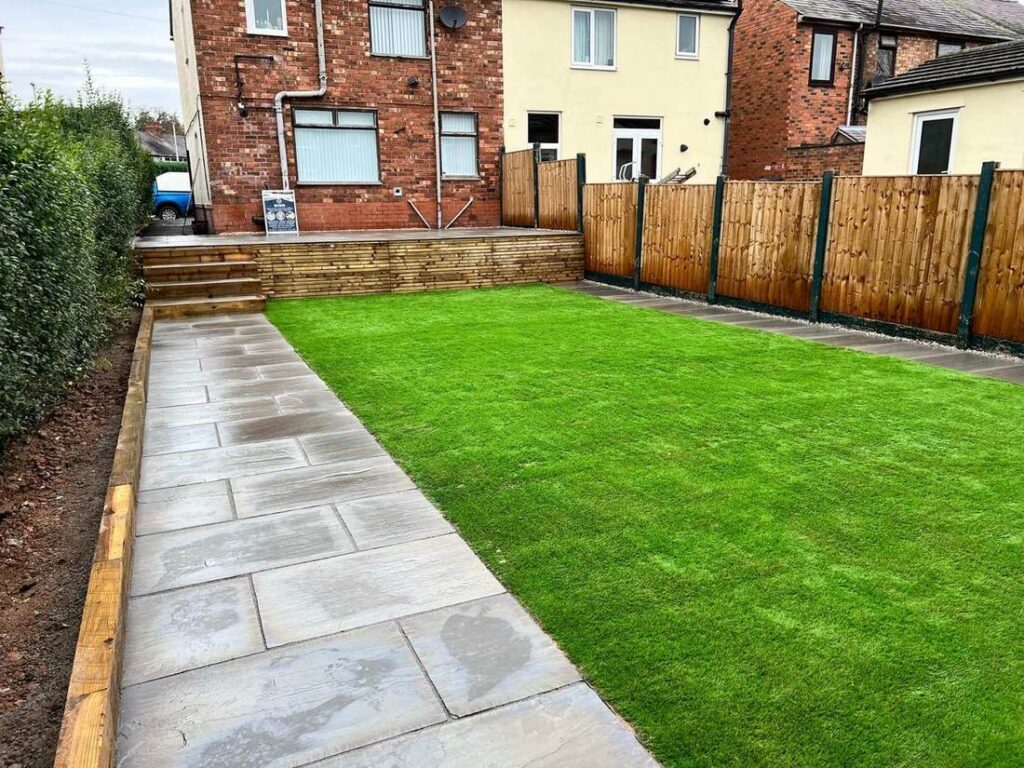 Porcelain path beside a new lawn with sleeper retaining wall