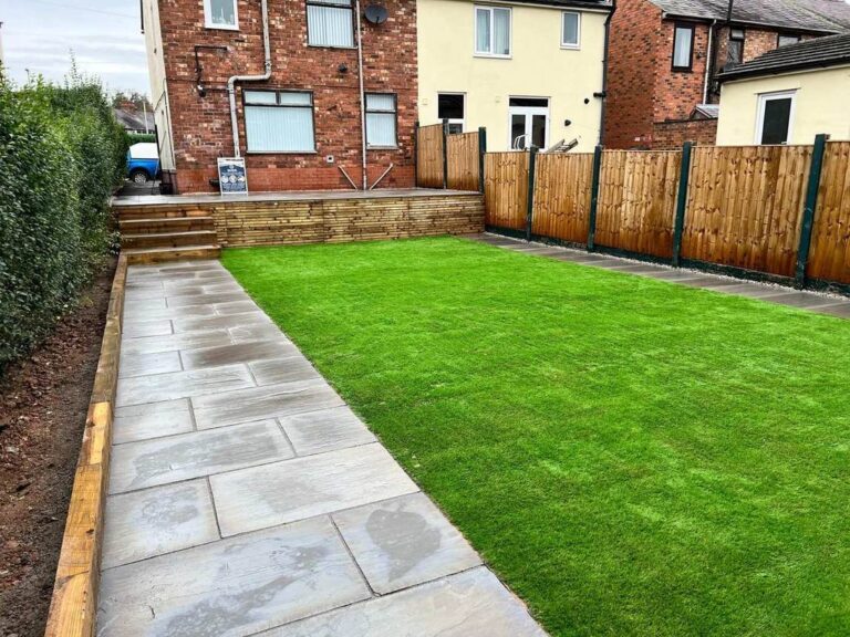 Porcelain path beside a new lawn with sleeper retaining wall