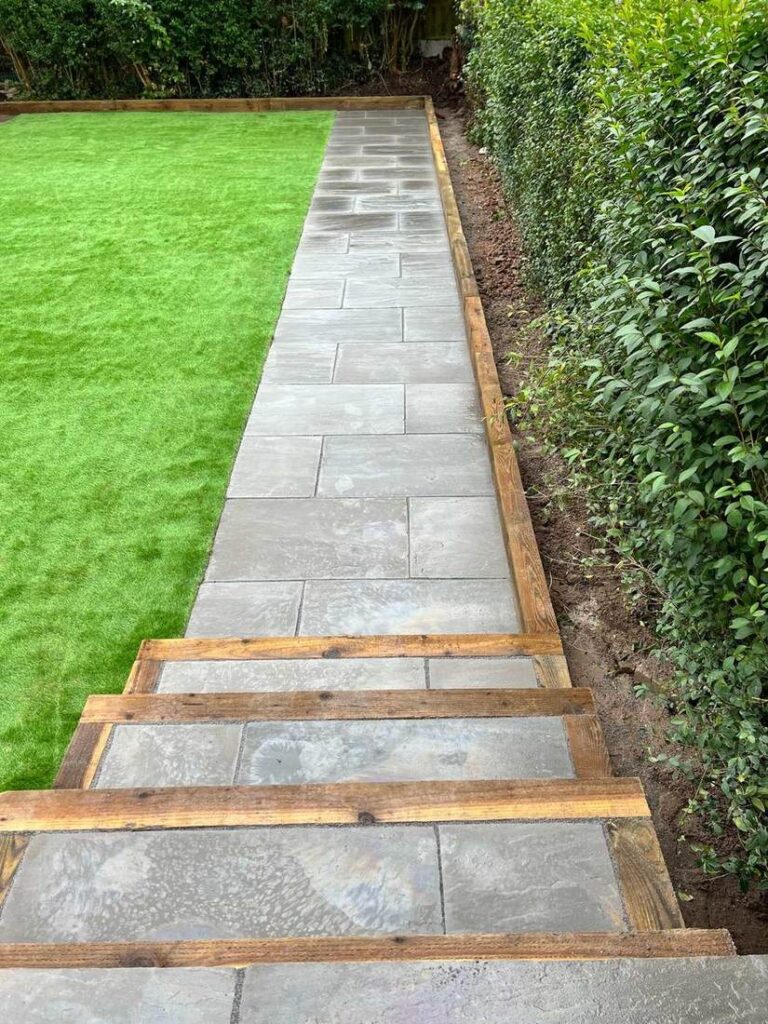Porcelain path with sleeper steps beside a lawn