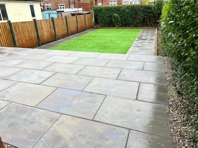 Grey porcelain patio leading to artificial grass