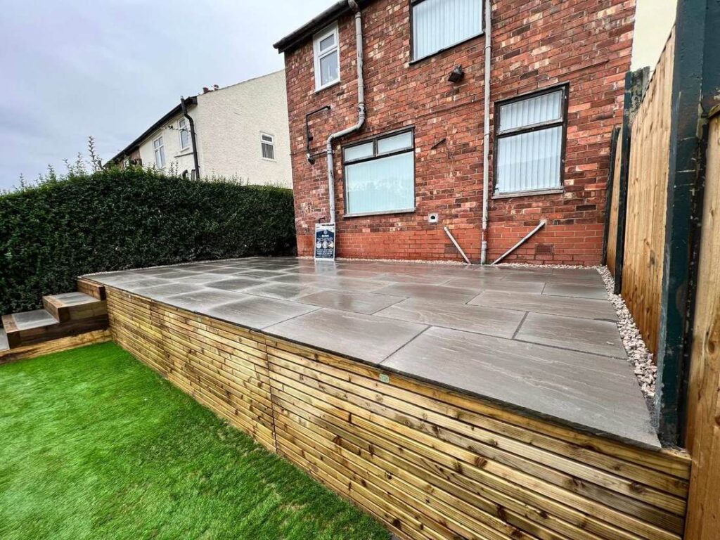 Raised porcelain patio clad in timber