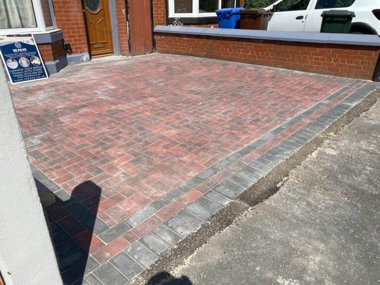 Red block paved driveway with a charcoal border