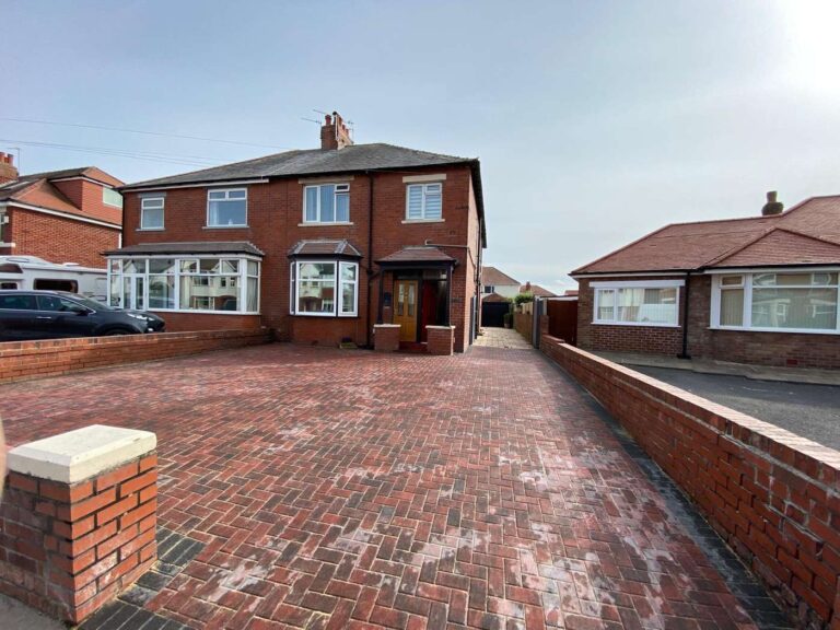 Red block paved driveway at a semi-detached house