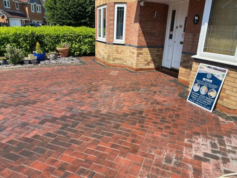 Red block paved driveway at a front door