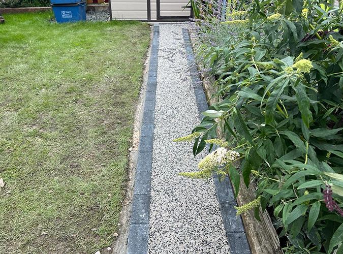 Narrow resin bound path beside a lawn
