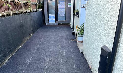 Tarmac path down the side of a house